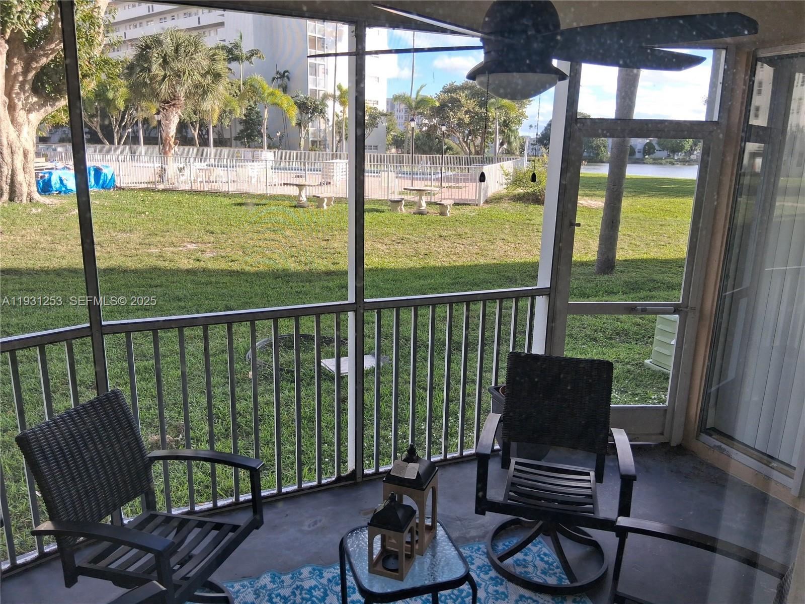 1750 Northeast 191st Street, Unit 1041 Miami, FL 33179 - Photo 17 of 17 a living room with furniture and a floor to ceiling window