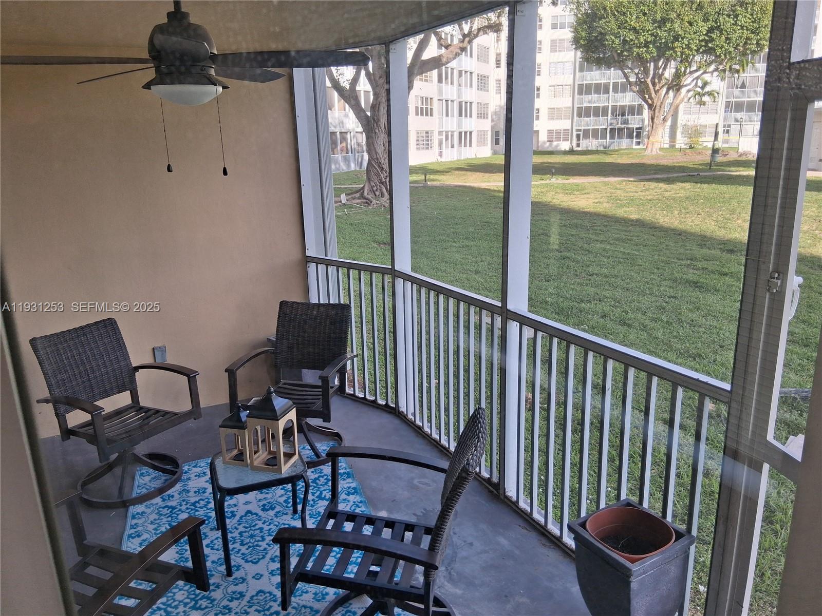 1750 Northeast 191st Street, Unit 1041 Miami, FL 33179 - Photo 10 of 17 a view of a chair and table in the balcony