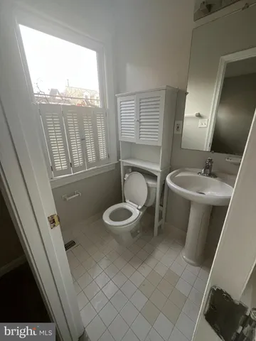 a bathroom with a sink toilet and mirror