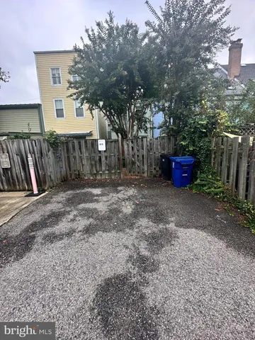 a view of backyard of house with deck and outdoor seating