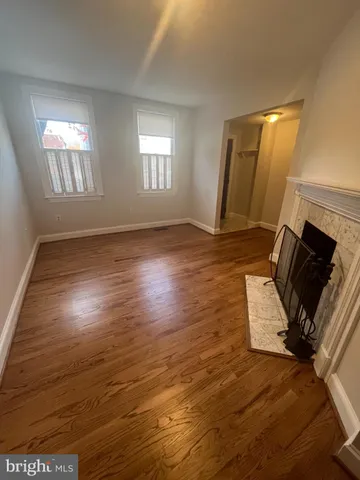 a view of a room with wooden floor and windows