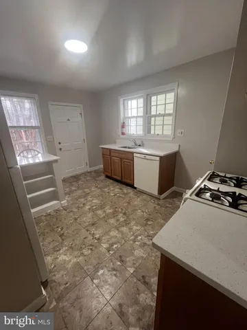 a kitchen with a stove a sink and a refrigerator