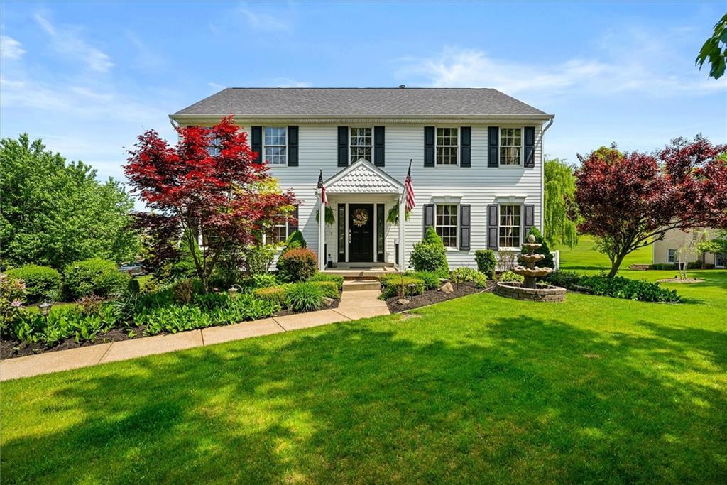 a front view of a house with a yard table and chairs