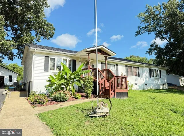 a front view of a house with a yard fountain