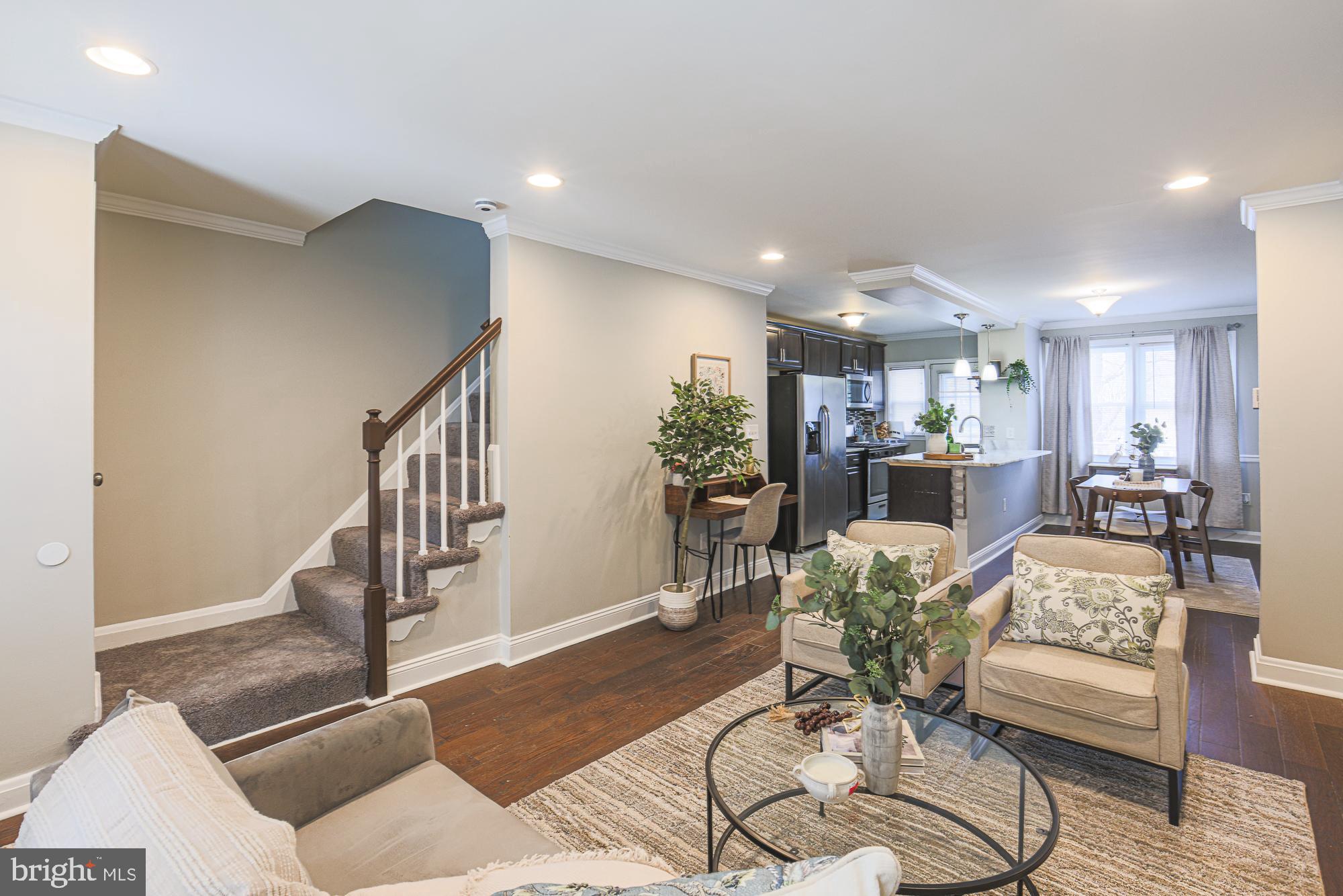 1322 Limit Avenue Baltimore, MD 21239 - Photo 1 of 31 a living room with furniture and a dining table with wooden floor