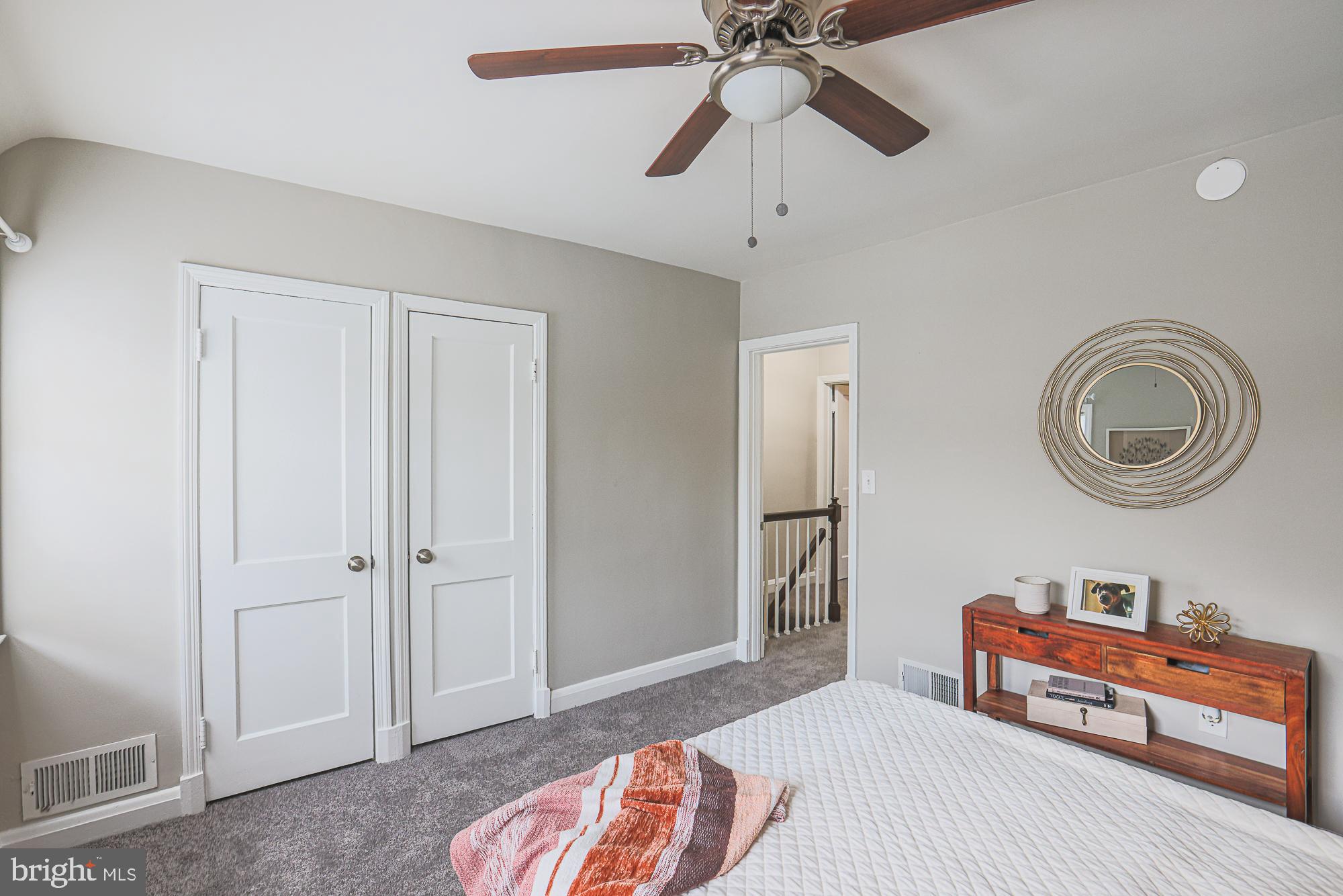 1322 Limit Avenue Baltimore, MD 21239 - Photo 16 of 31 a bedroom with a bed and a chandelier