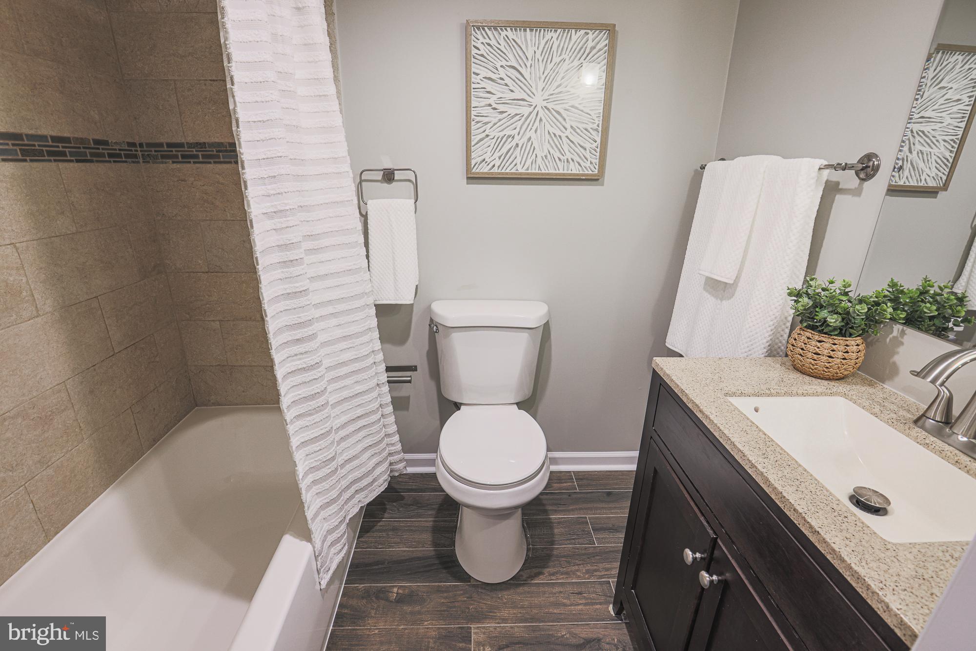 1322 Limit Avenue Baltimore, MD 21239 - Photo 27 of 31 a bathroom with a sink toilet and a mirror
