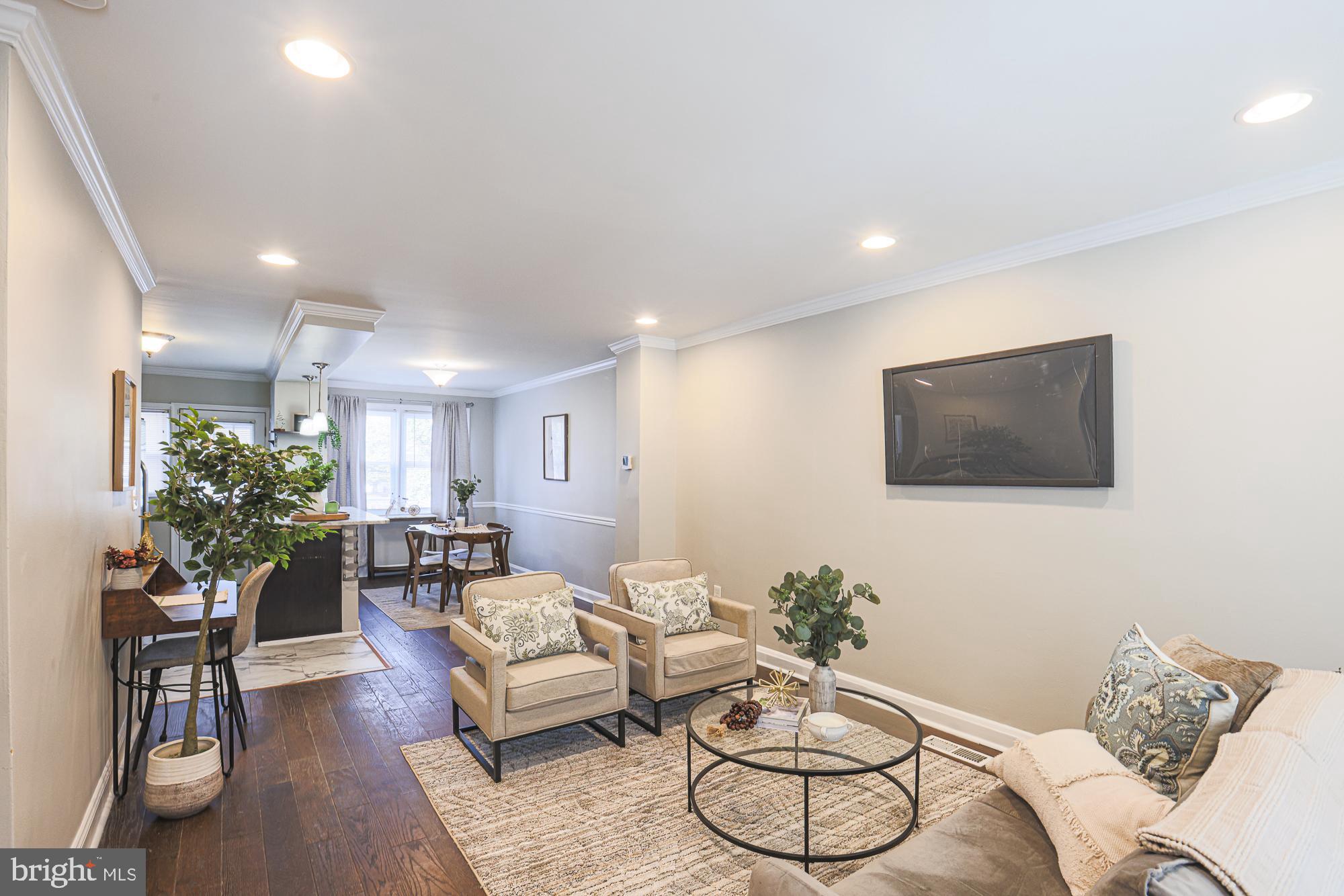 1322 Limit Avenue Baltimore, MD 21239 - Photo 4 of 31 a living room with furniture potted plant and a painting