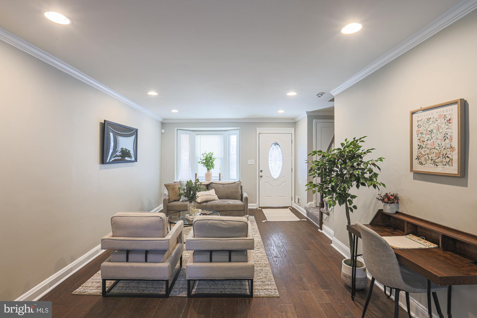 1322 Limit Avenue Baltimore, MD 21239 - Photo 6 of 31 a living room with furniture a potted plant and wooden floor