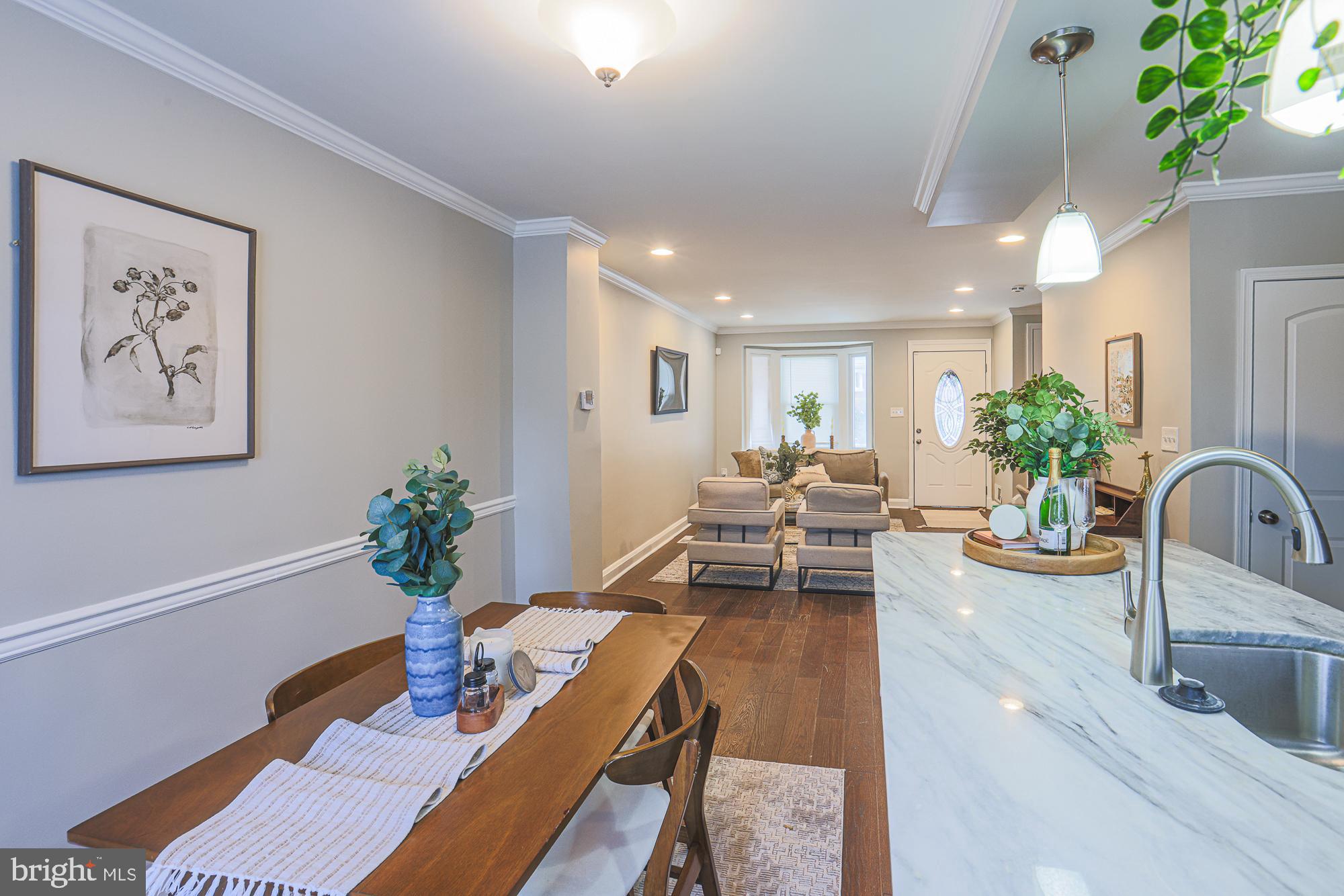 1322 Limit Avenue Baltimore, MD 21239 - Photo 9 of 31 a living room with furniture potted plant and kitchen view