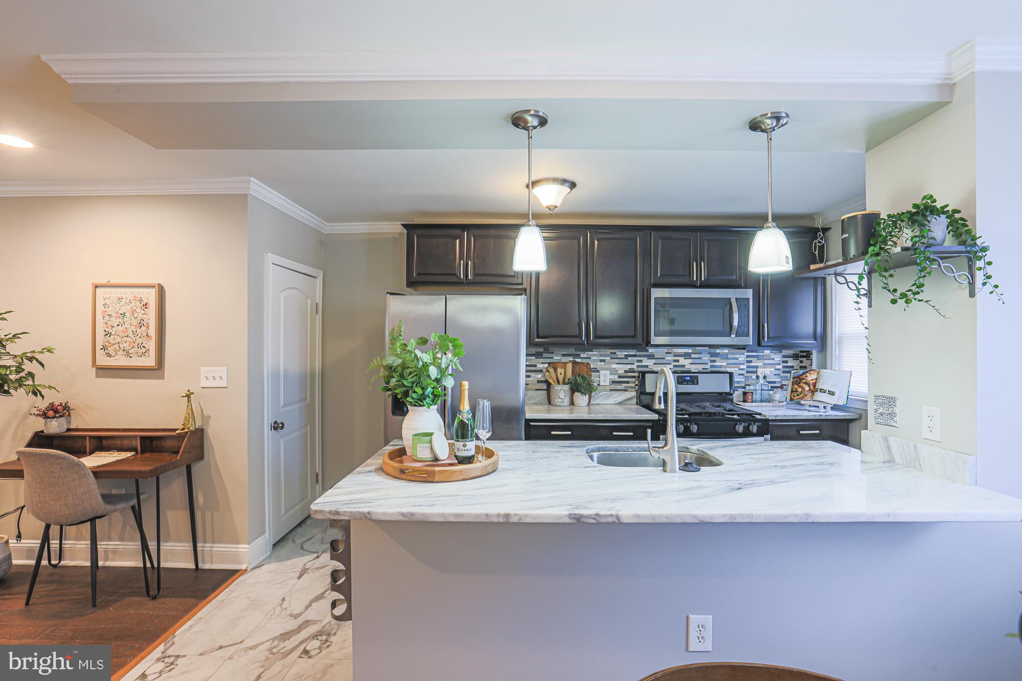 1322 Limit Avenue Baltimore, MD 21239 - Photo 10 of 31 a kitchen with counter top space and wooden floor