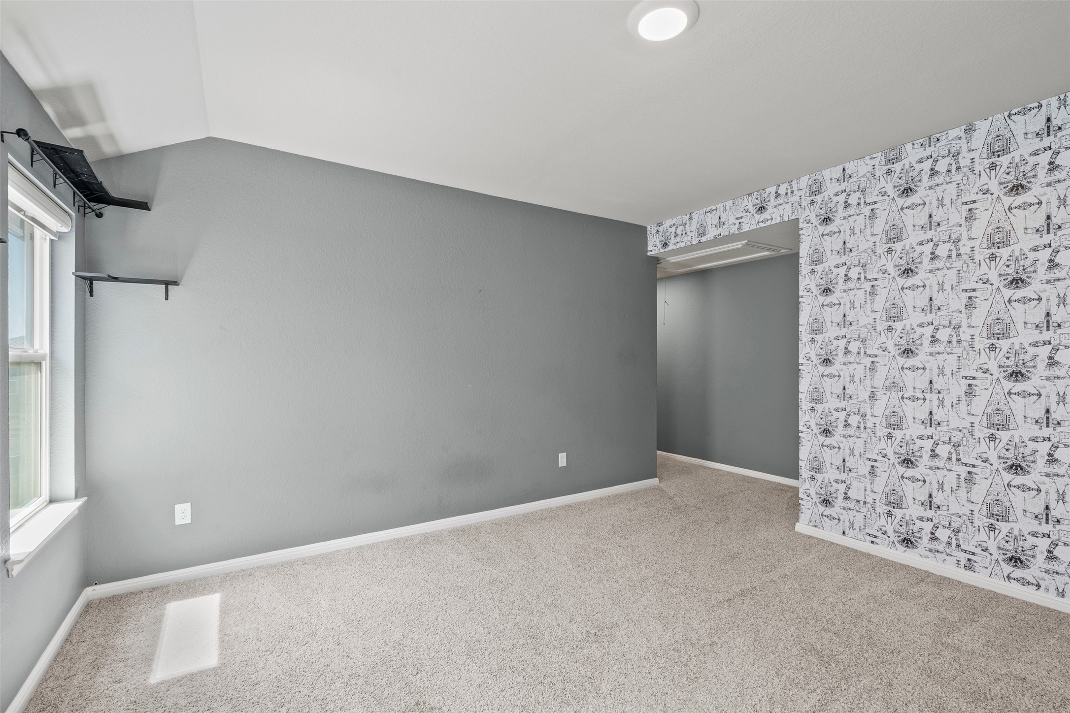 120 Ellinger Road Georgetown, TX 78626 - Photo 28 of 28 Open room with gray painted walls and patterned wallpaper accent