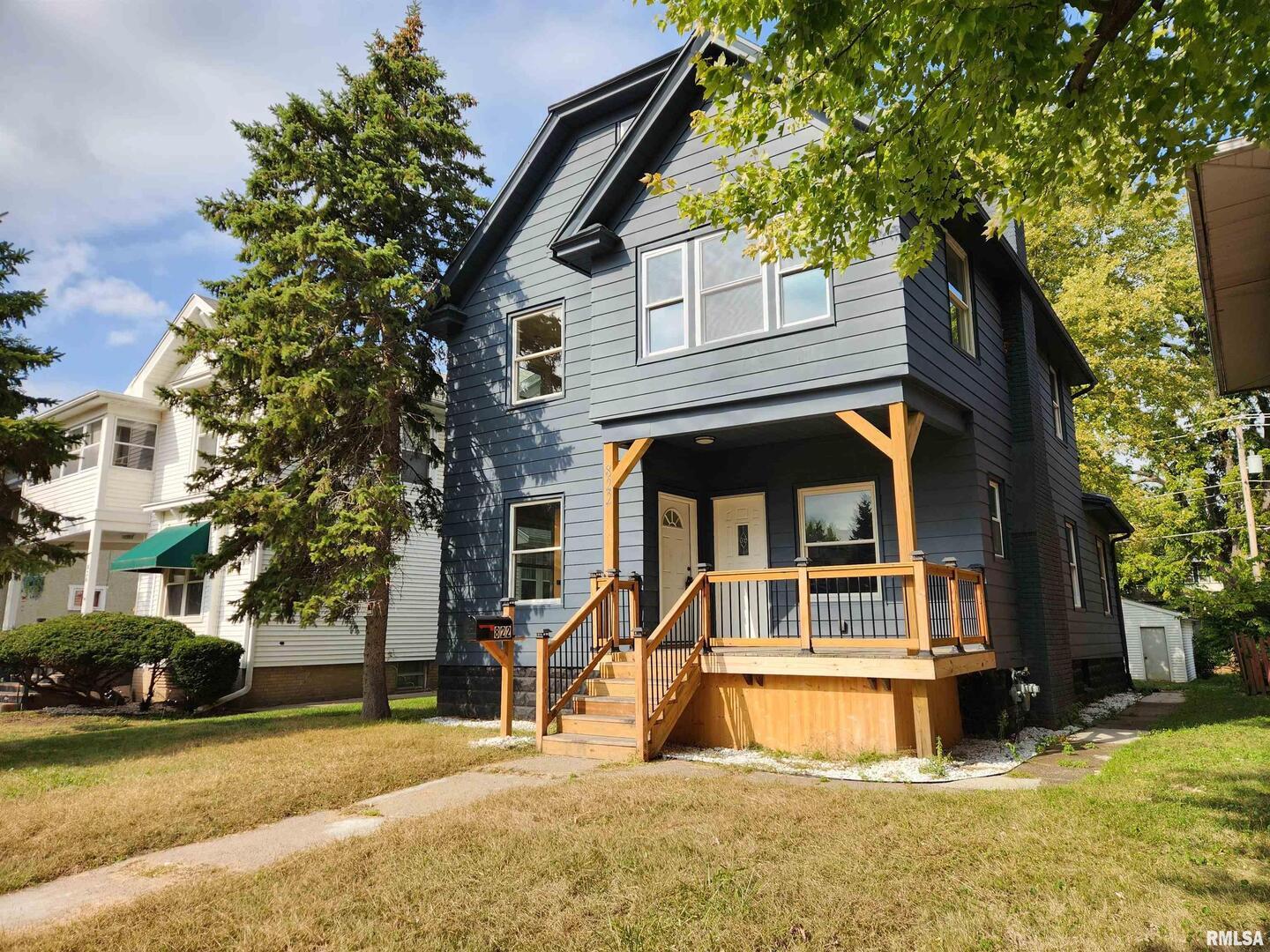 a view of a house with a large tree