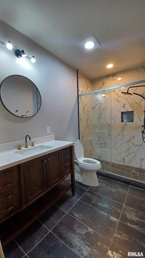 822 6th Avenue South Clinton, IA 52732 - Photo 12 of 28 a bathroom with a double vanity sink toilet and mirror