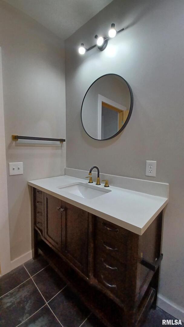 822 6th Avenue South Clinton, IA 52732 - Photo 13 of 28 a bathroom with a sink and a mirror