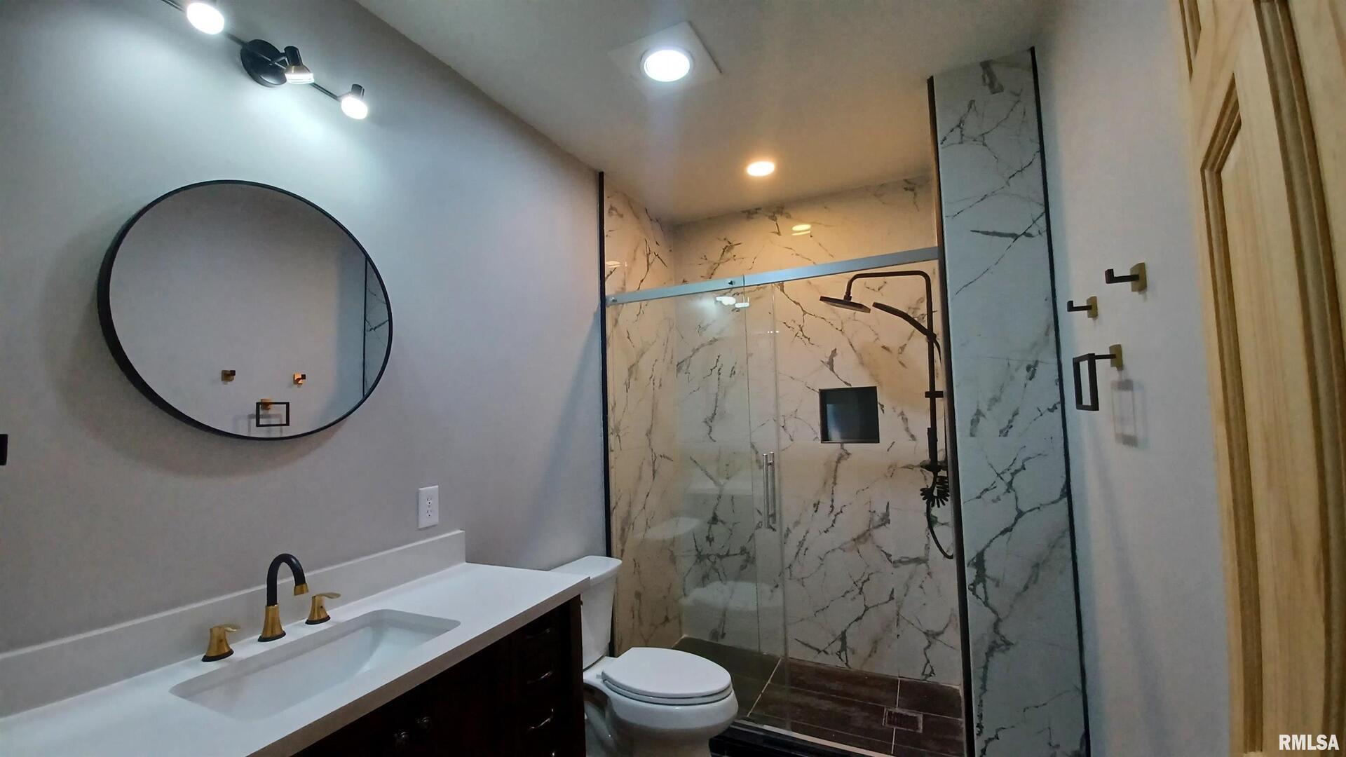 822 6th Avenue South Clinton, IA 52732 - Photo 14 of 28 a bathroom with a sink a toilet and shower