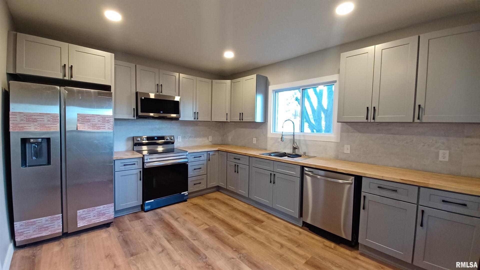 822 6th Avenue South Clinton, IA 52732 - Photo 2 of 28 a kitchen with stainless steel appliances granite countertop a refrigerator sink and microwave