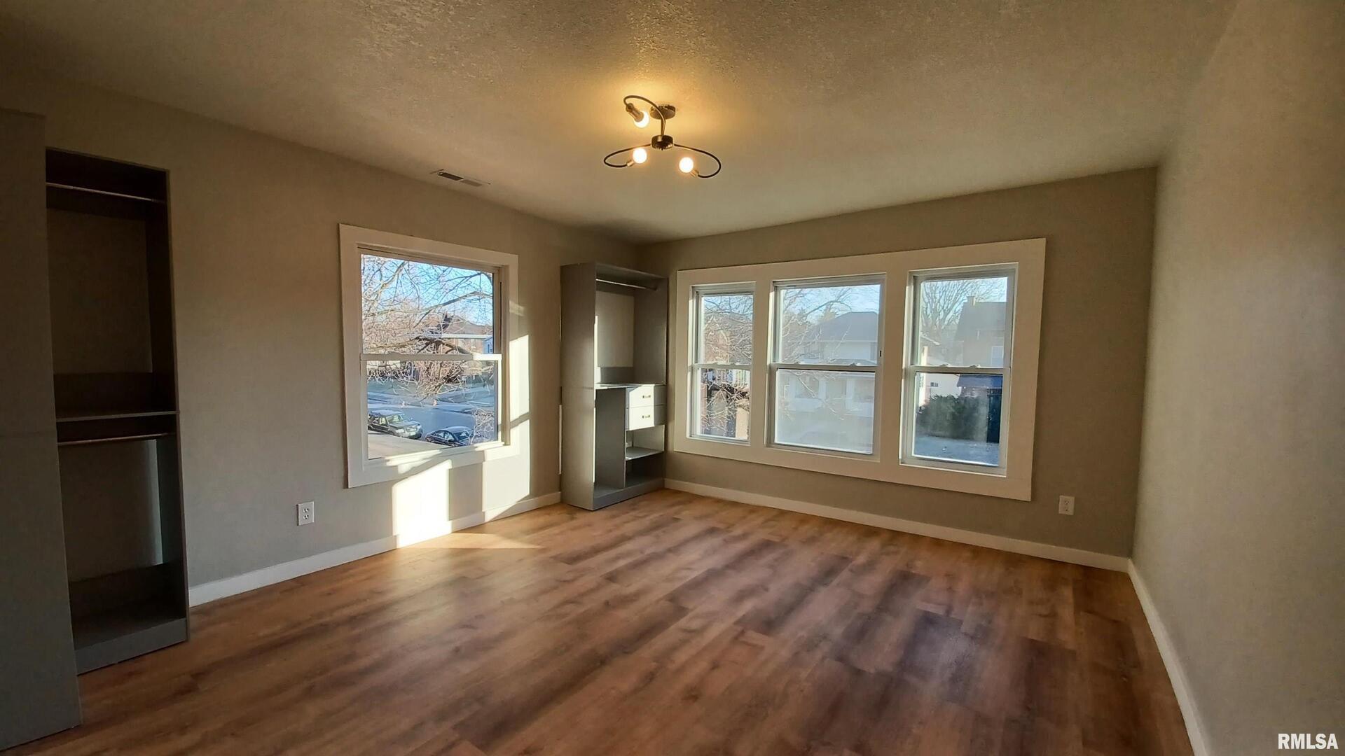 822 6th Avenue South Clinton, IA 52732 - Photo 21 of 28 a view of an empty room with a window and wooden floor