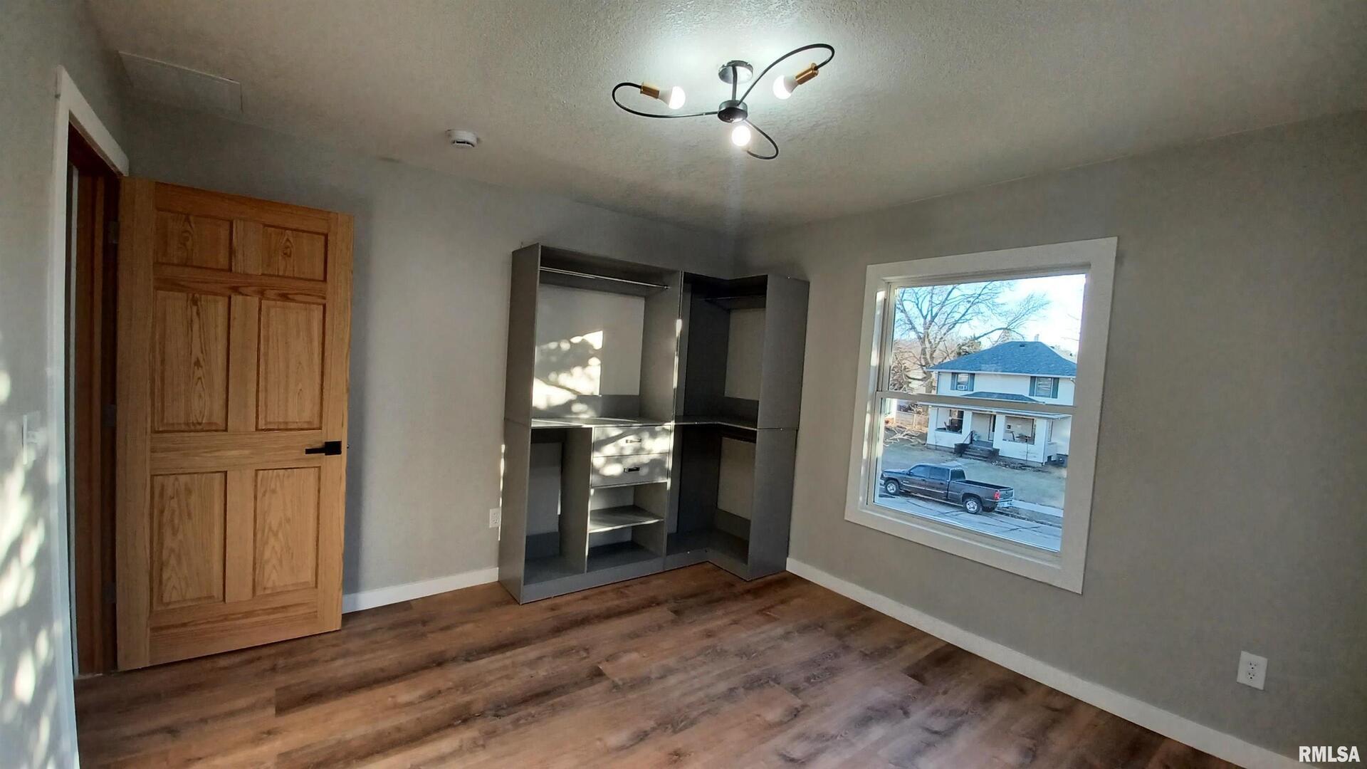 822 6th Avenue South Clinton, IA 52732 - Photo 22 of 28 wooden floor in an empty room with a window