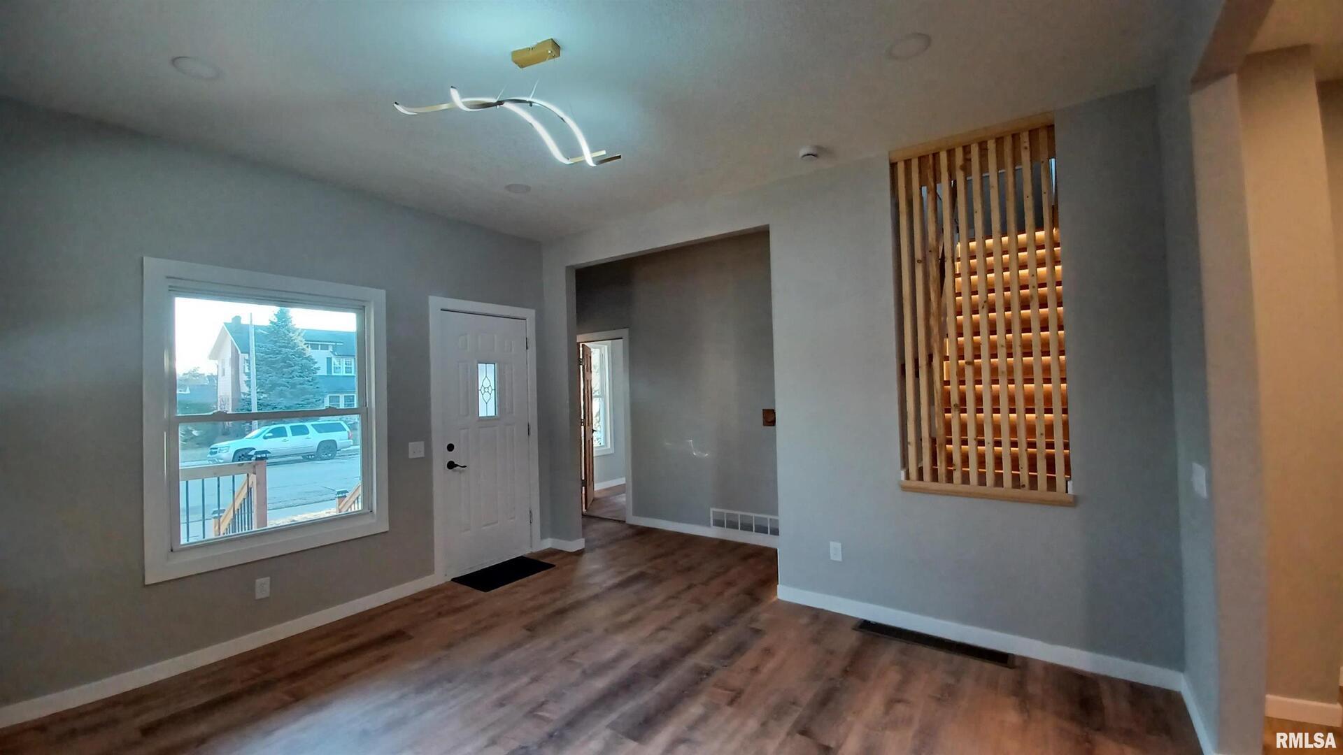 822 6th Avenue South Clinton, IA 52732 - Photo 24 of 28 a view of an empty room with wooden floor and a window
