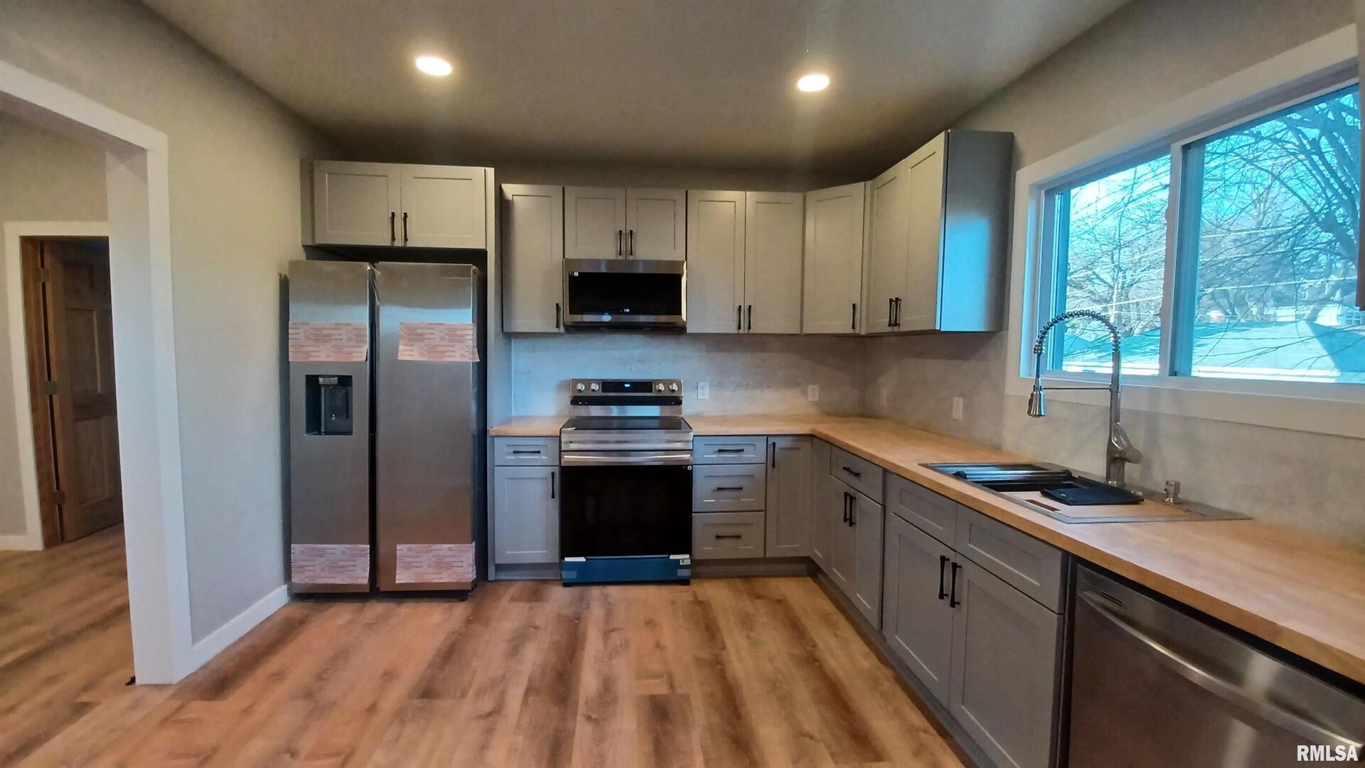 822 6th Avenue South Clinton, IA 52732 - Photo 3 of 28 a kitchen with stainless steel appliances granite countertop a refrigerator sink and stove