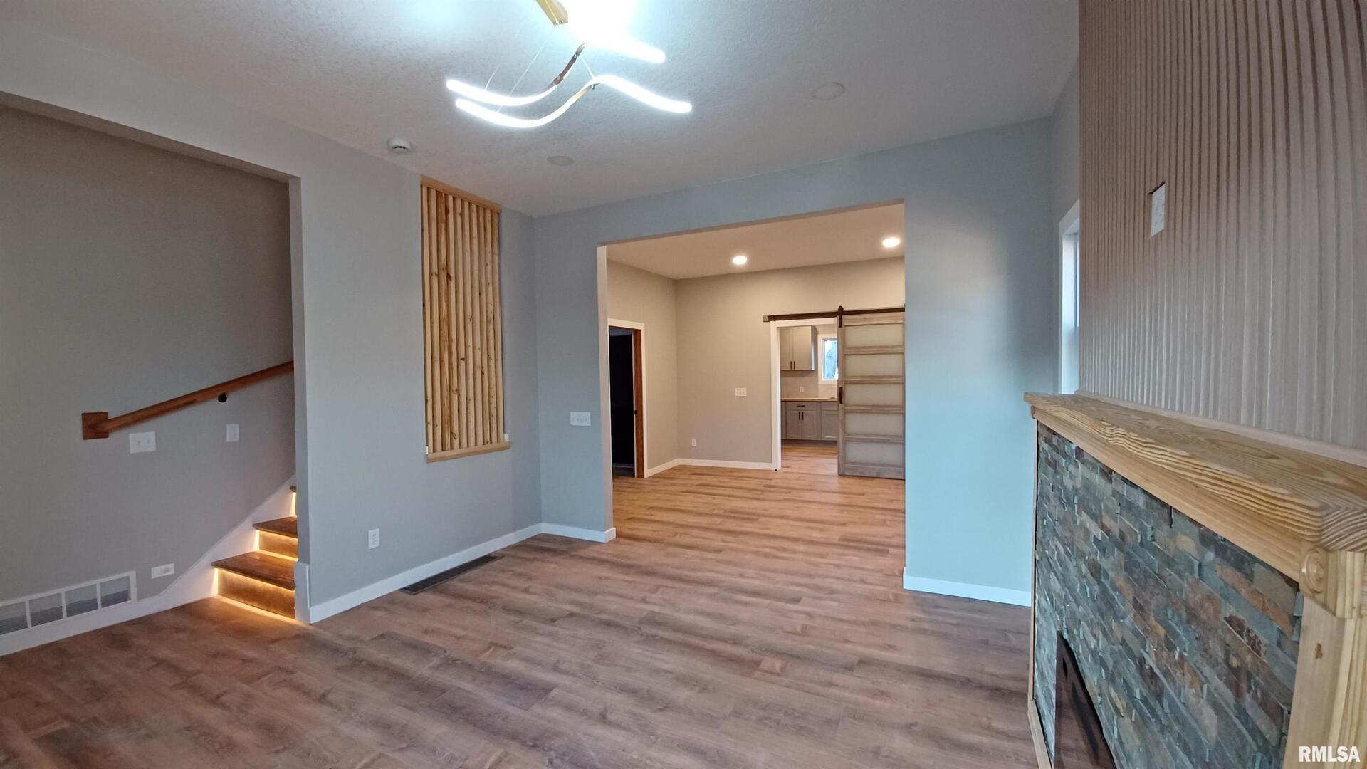 822 6th Avenue South Clinton, IA 52732 - Photo 7 of 28 an empty room with wooden floor and windows