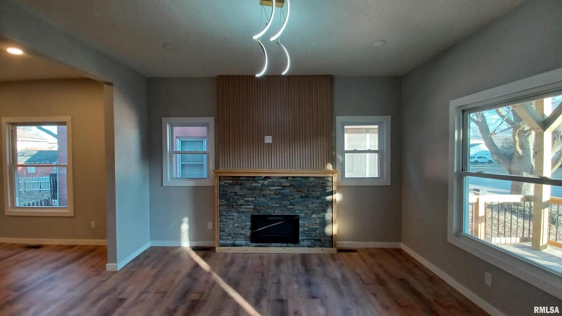 822 6th Avenue South Clinton, IA 52732 - Photo 8 of 28 wooden floor fireplace and windows in an empty room