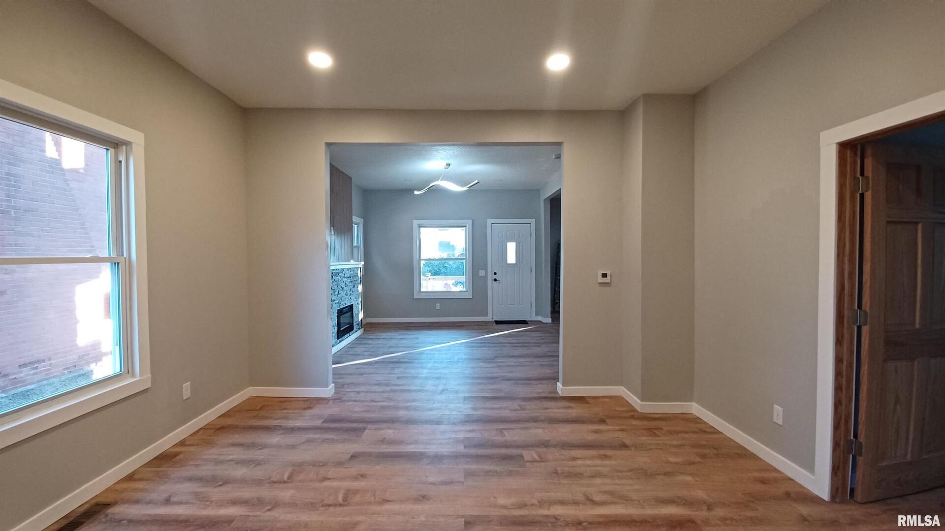 822 6th Avenue South Clinton, IA 52732 - Photo 9 of 28 an empty room with wooden floor and windows