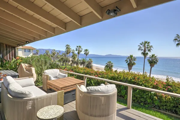 a view of a chairs and table in patio