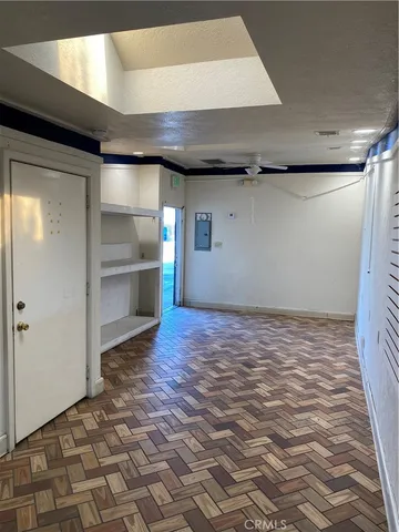 an empty room with closet and a bathroom