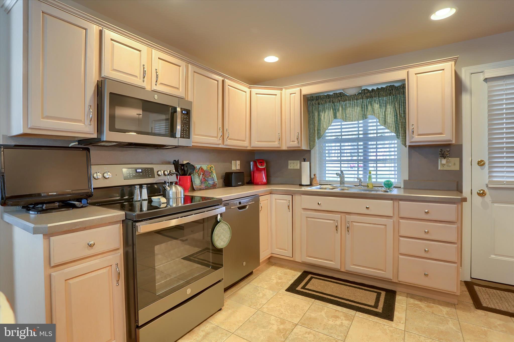 2406 Roundtop Road Middletown, PA 17057 - Photo 16 of 49 a kitchen with granite countertop white cabinets stainless steel appliances and a window