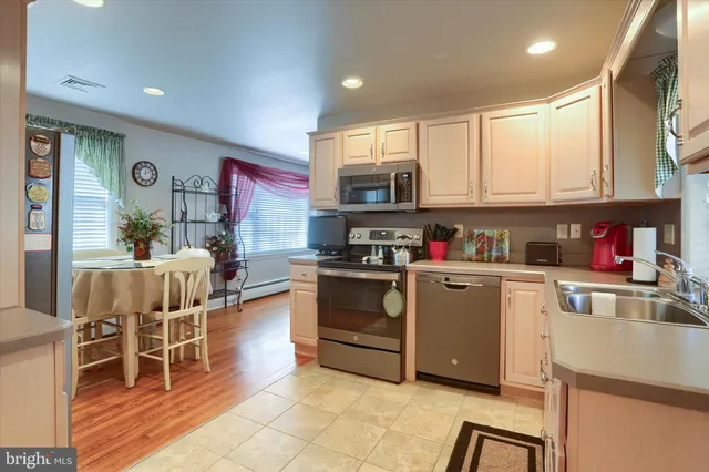 a kitchen with stainless steel appliances granite countertop a refrigerator sink and cabinets