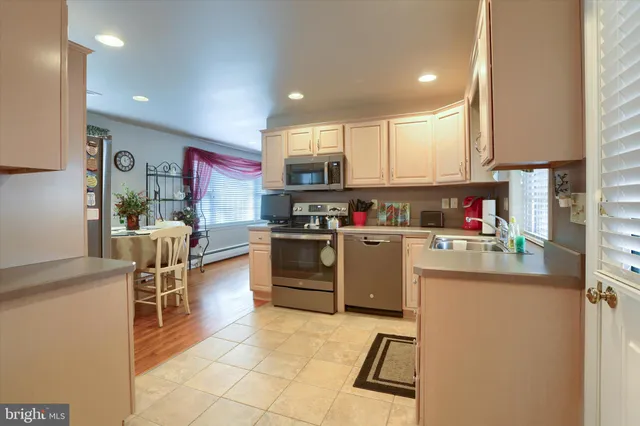 a kitchen with stainless steel appliances granite countertop a refrigerator sink and cabinets