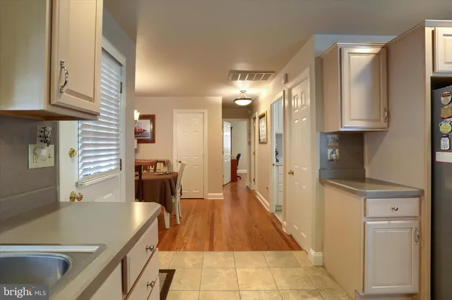 a kitchen with stainless steel appliances granite countertop a refrigerator a stove and a sink