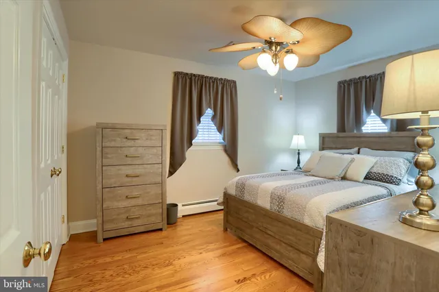 a bedroom with a bed chandelier and a window