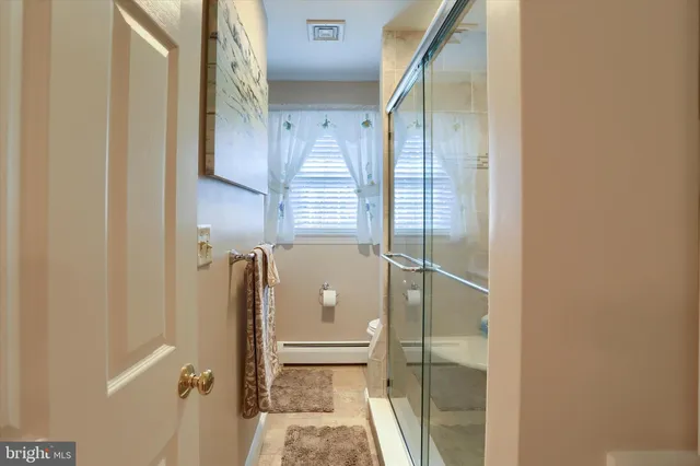 a bathroom with a shower and a sink