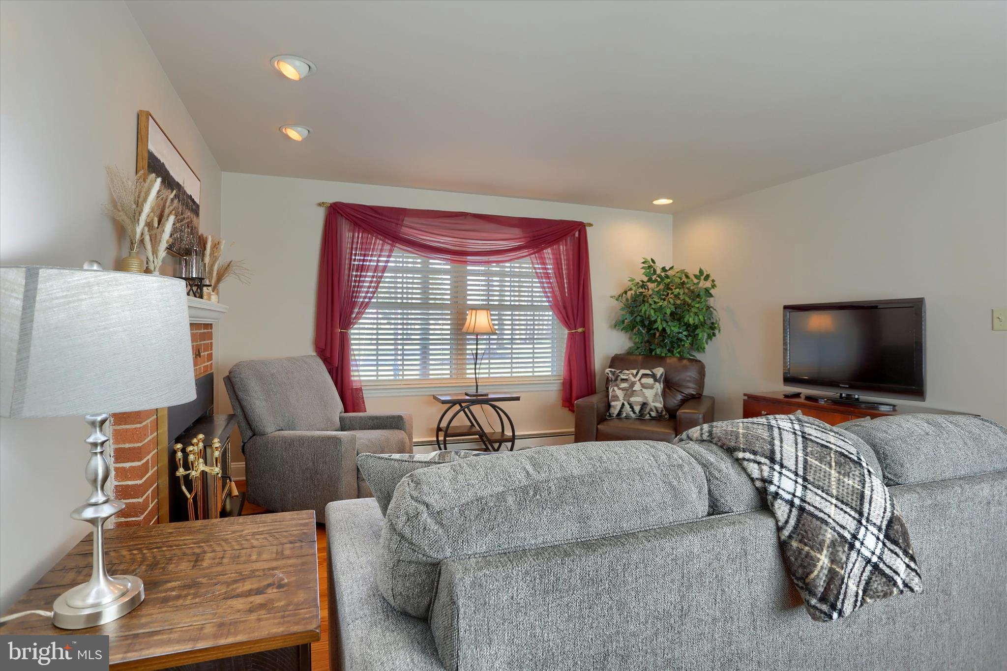 2406 Roundtop Road Middletown, PA 17057 - Photo 8 of 49 a living room with furniture and a flat screen tv