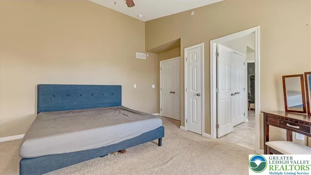 a bedroom with a bed and a television