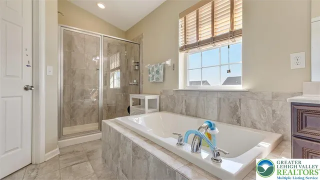 a bathroom with a tub a sink and a shower