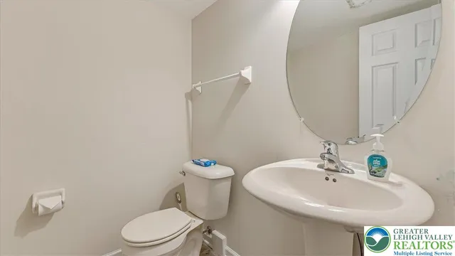 a white toilet sitting next to a white sink