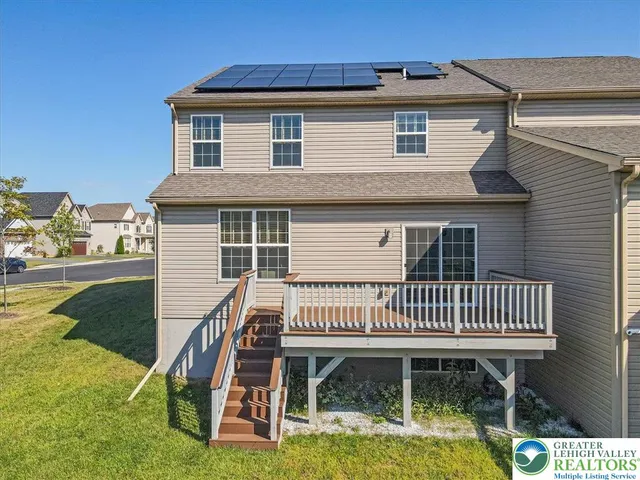 a view of a house with backyard and porch