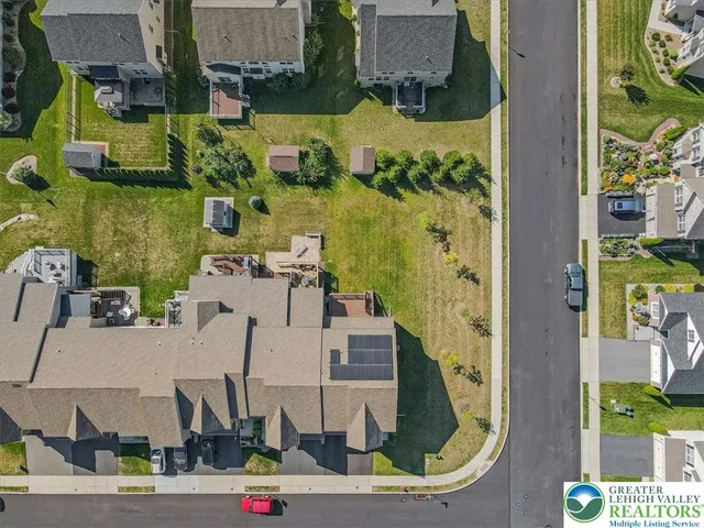 an aerial view of residential houses with outdoor space