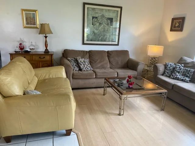 a living room with furniture and painting on the wall