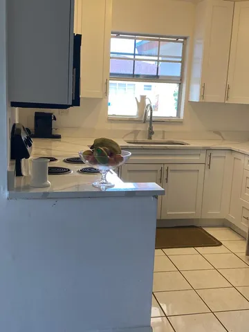 a kitchen with a sink a stove a microwave and cabinets