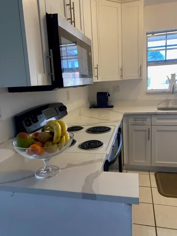 a kitchen with a sink a stove and cabinets