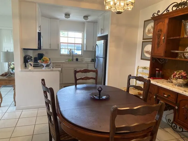 a view of a dining room with furniture and chandelier