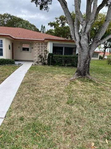 a large tree in front of a house