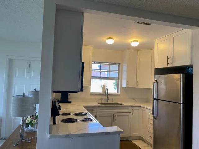 a kitchen with a refrigerator a sink and a stove