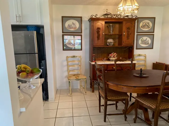 a dining room with furniture and chandelier