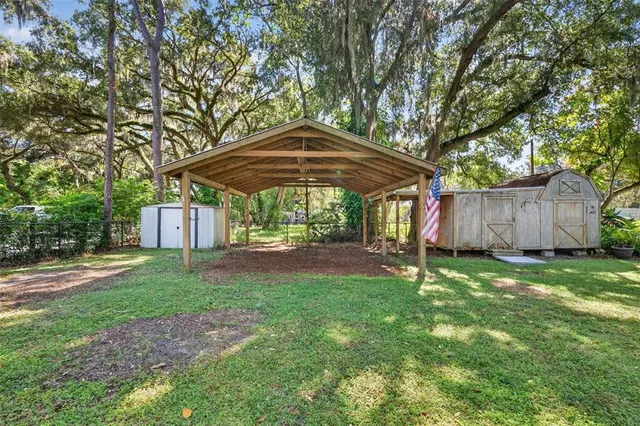 a view of a backyard with table and chairs
